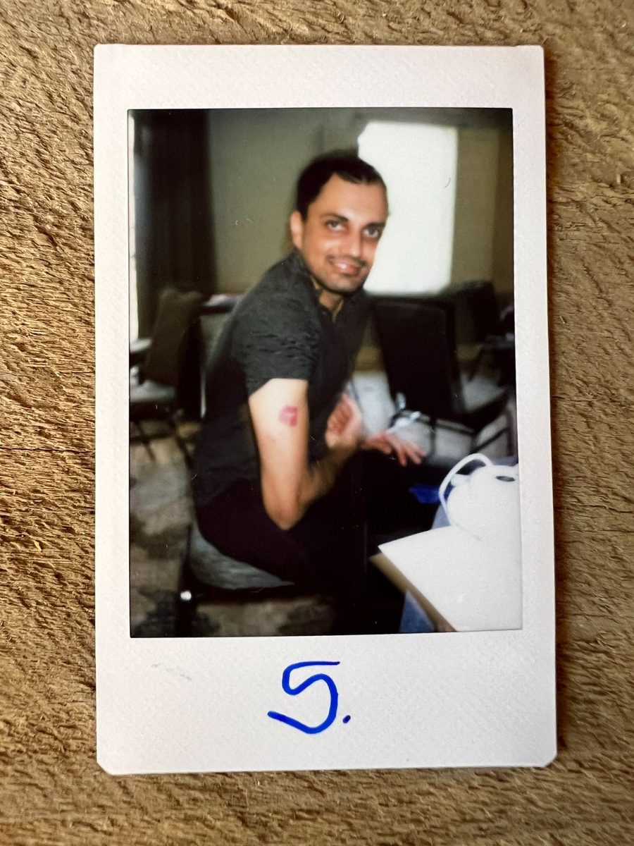 Polaroid of a Runpod teammate at their desk