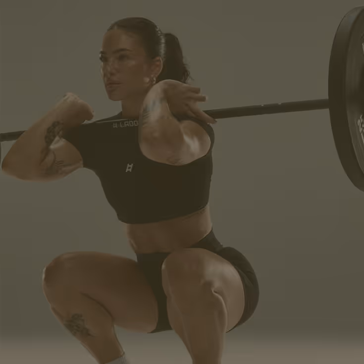 Woman squatting with a barbell across her shoulders