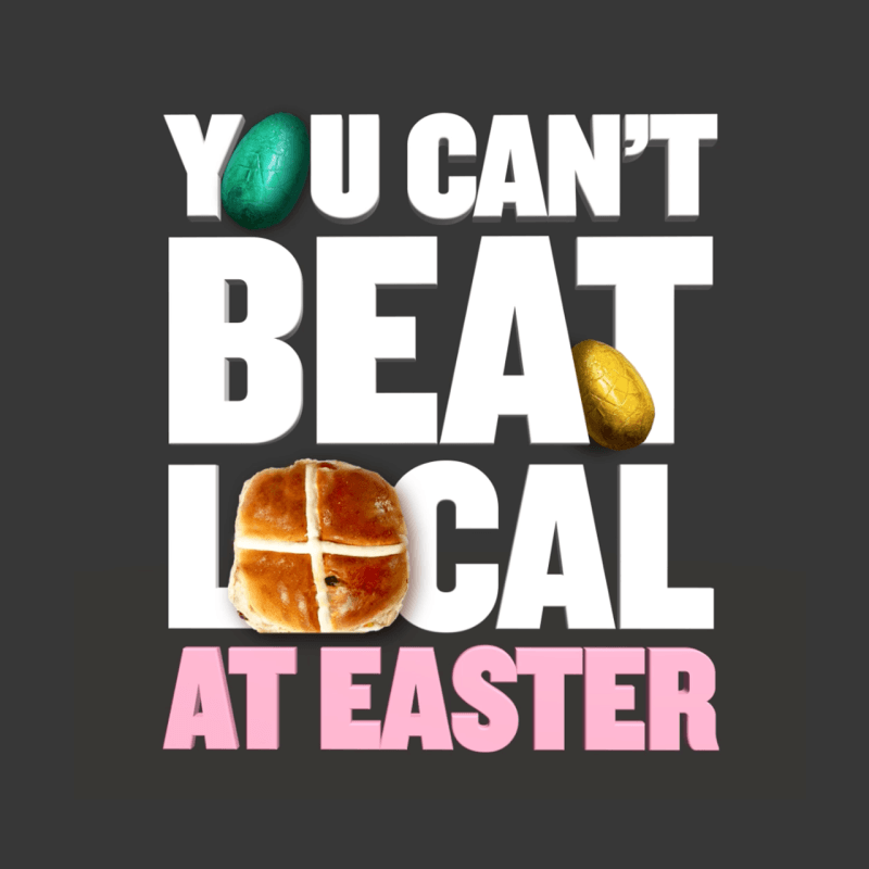 Graphic text saying 'You can't beat local at Easter' with a green and gold Easter egg and a hot cross bun on a dark background.