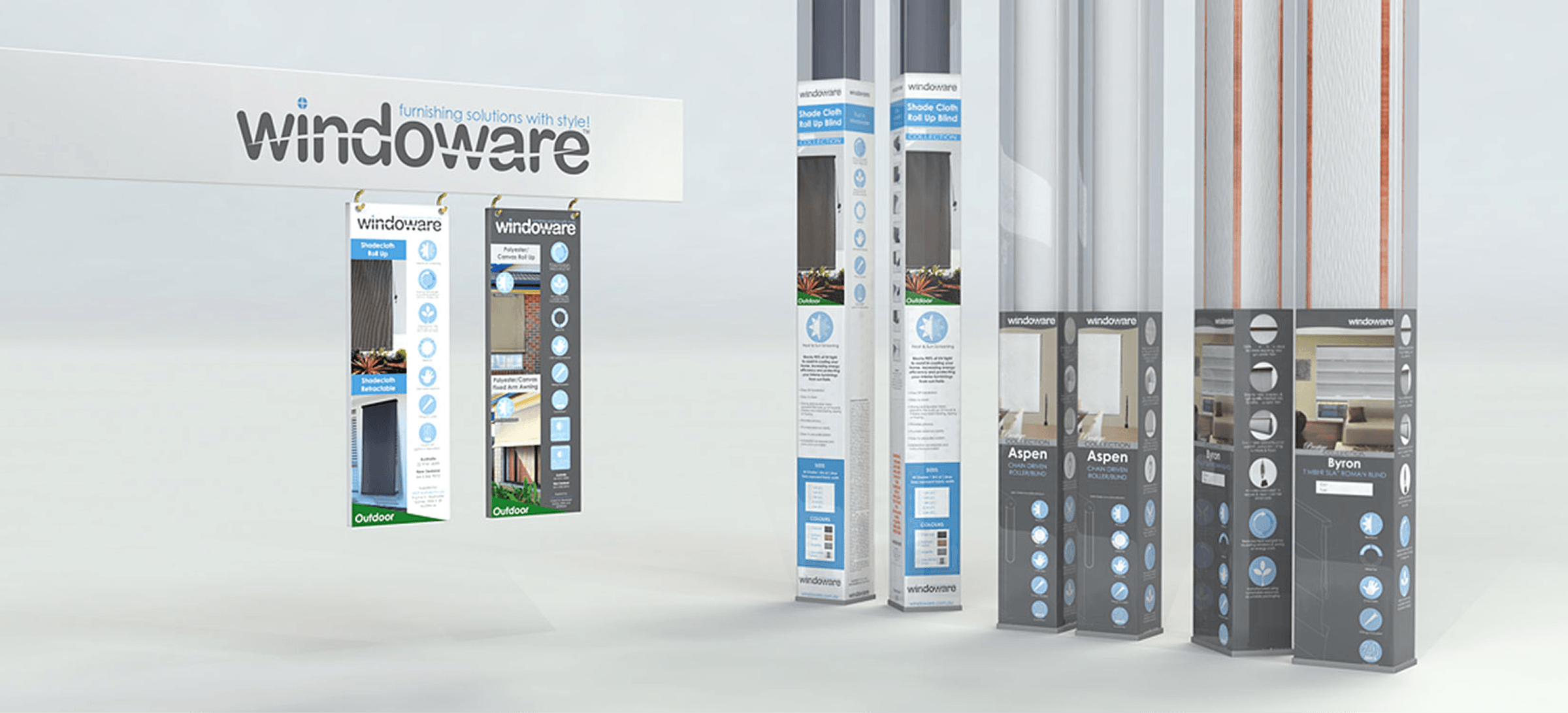 Display of Windoware branded window covering products including shade cloth roll-up blinds, polyester/canvas roll-up awnings, chain driven roller blinds, and Roman blinds.