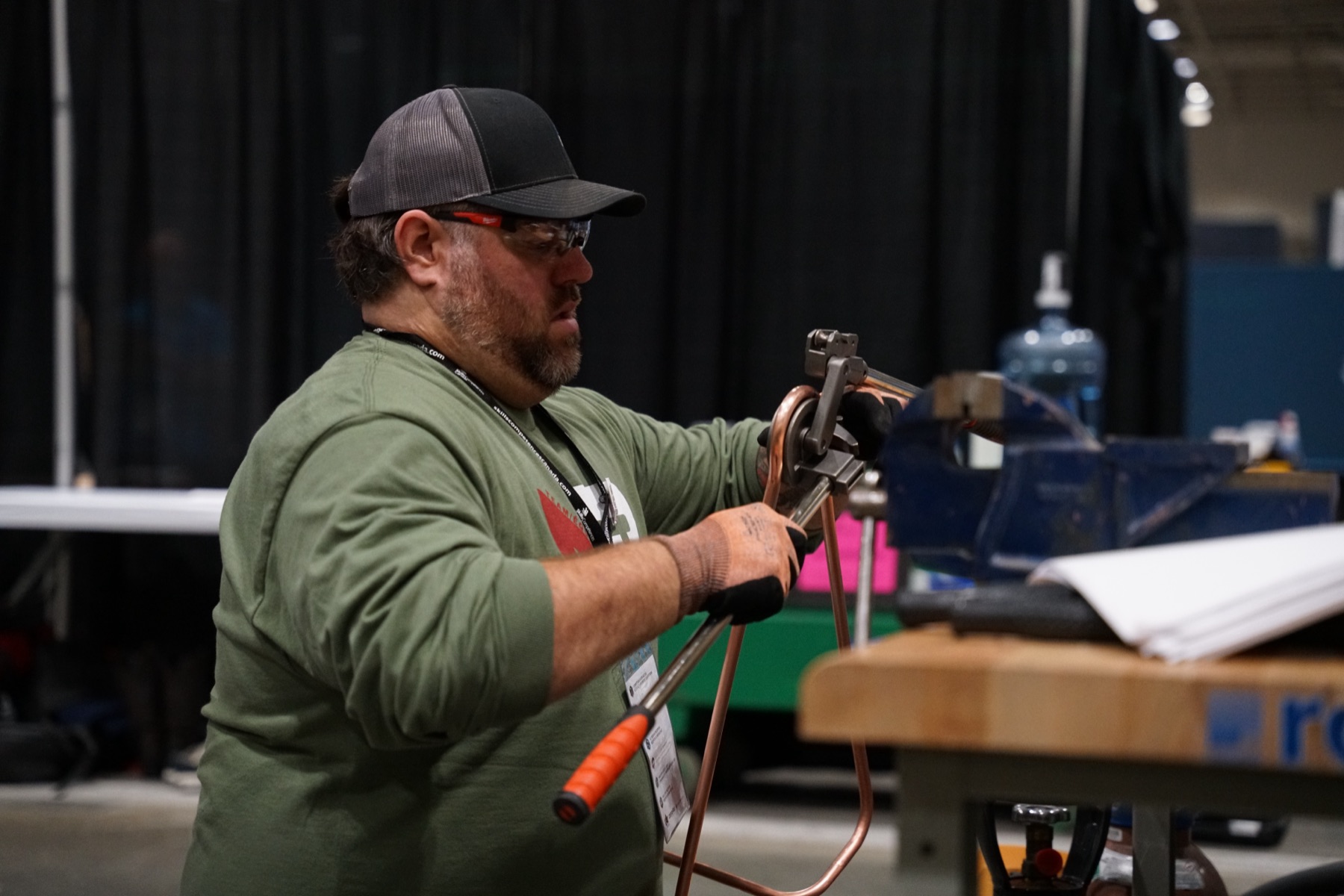 Competitor soldering at a workbench during a skilled trades competition