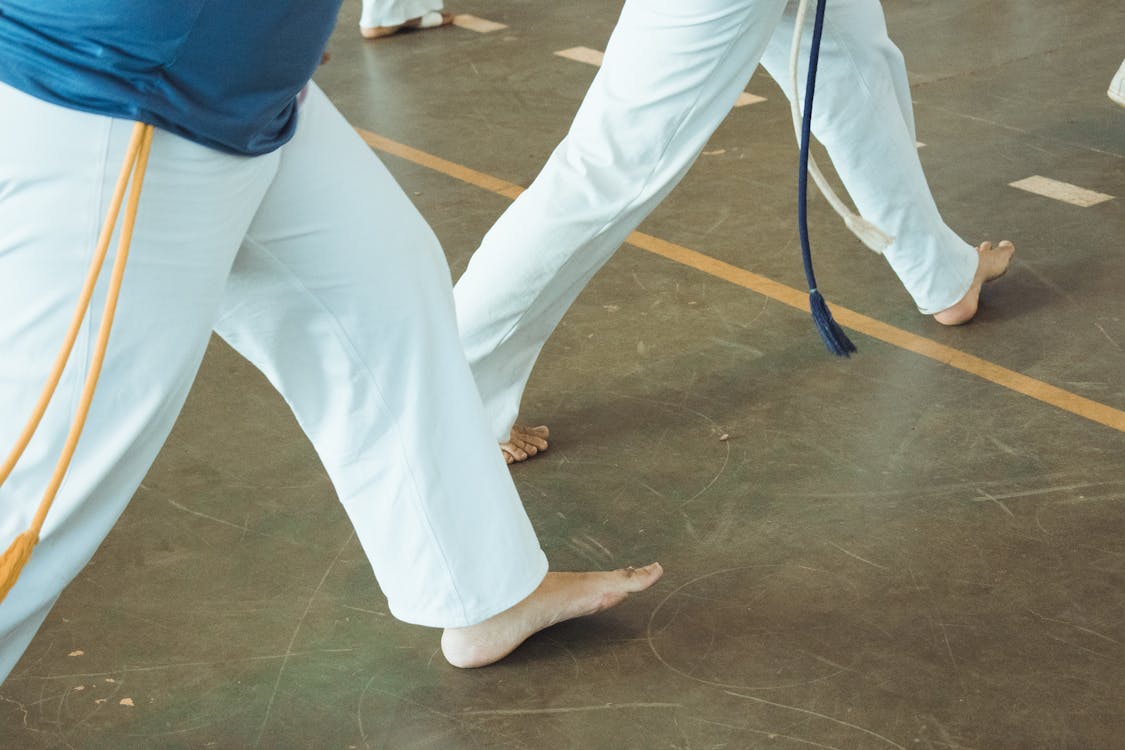 Martial arts practitioners training together during a dynamic practice session in traditional uniforms