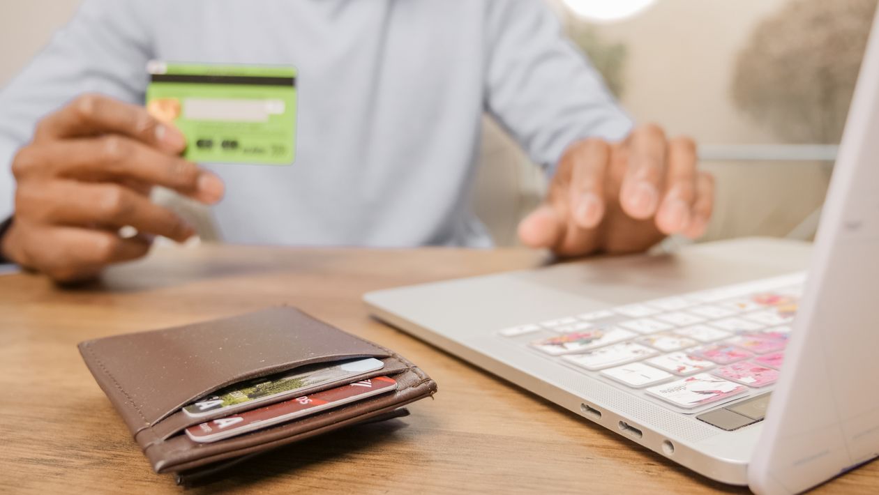 A parent enters bank card details on a laptop to set up a monthly dojo membership