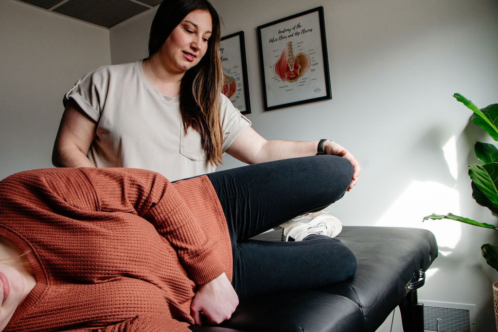  Patient working with a pelvic floor occupational therapist on breathwork and movement exercises at a pelvic wellness clinic in Midland, MI