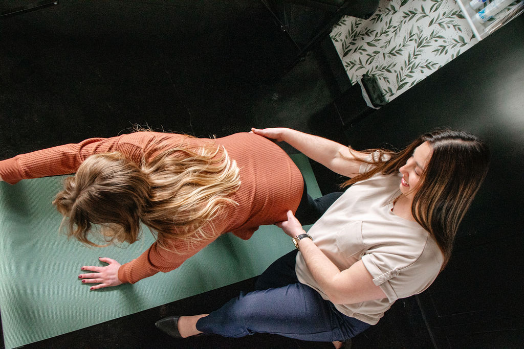 occupational therapist conducting a one-on-one pelvic health session with a patient in a private treatment room