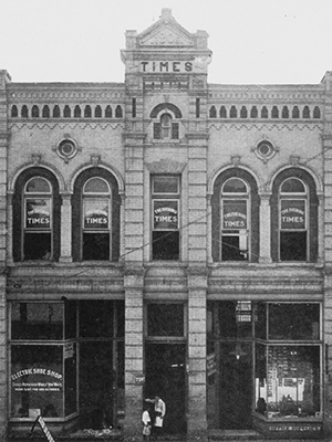 old photograph of the Raleigh Times building showing the pediment with the 1906 date