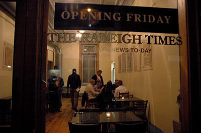 people chatting inside a restaurant as seen through the window