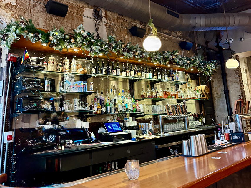 a bar decorated with Christmas garland and lights