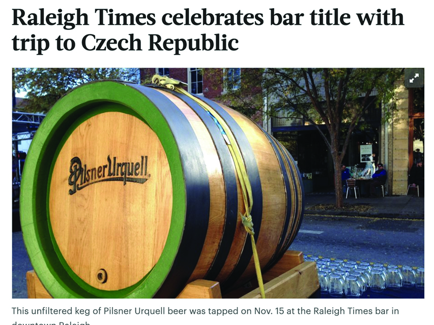 a large barrel of Pilsner Urquell beer in the street