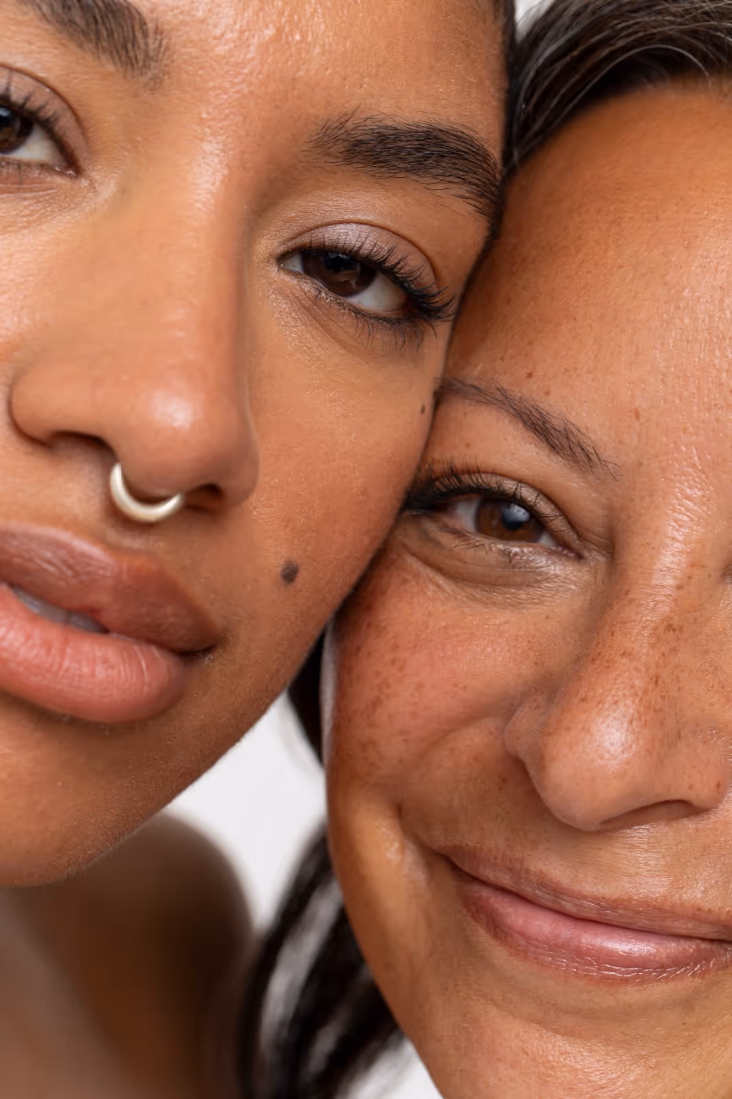 Close-up of two women showcasing lash results
