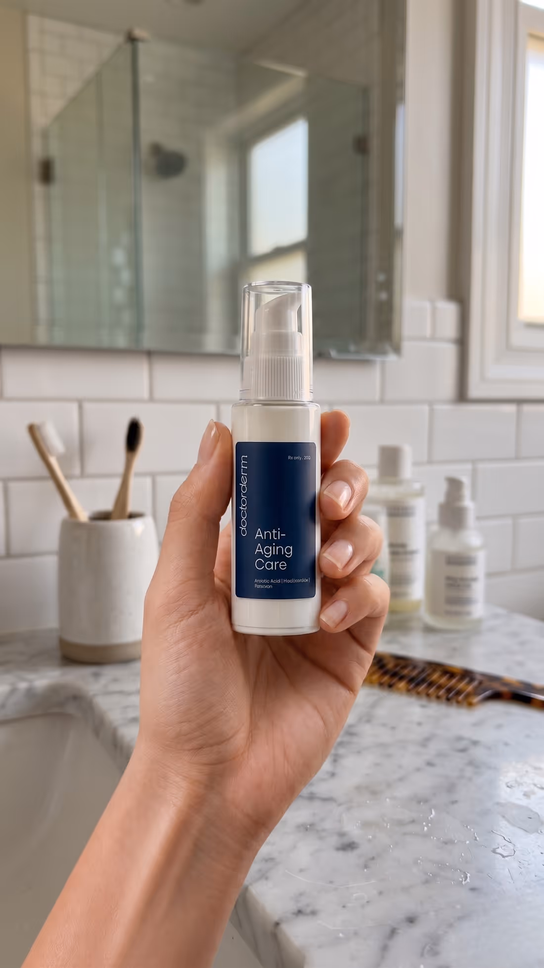 A hand holding DoctorDerm Anti-Aging Care