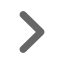 Gray right-pointing chevron or arrow icon