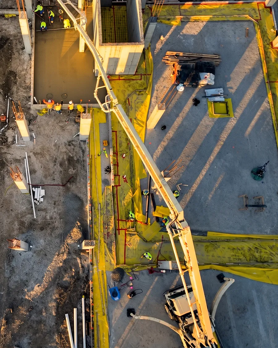 A pump boom placing concrete, seen from above