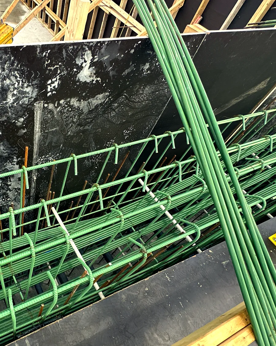 A rebar cage tied along the wall forms