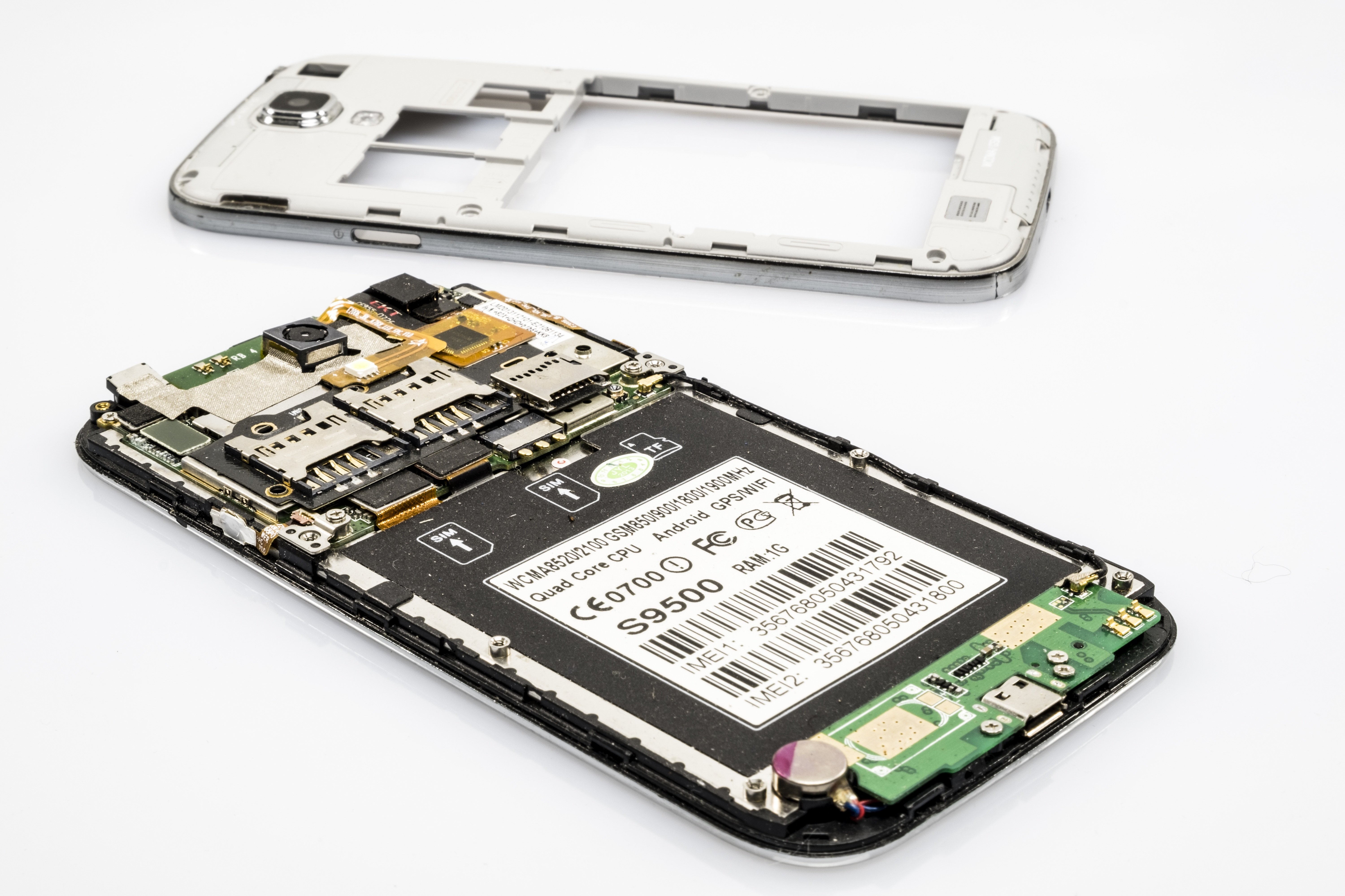 Disassembled smartphone showing its motherboard and back housing