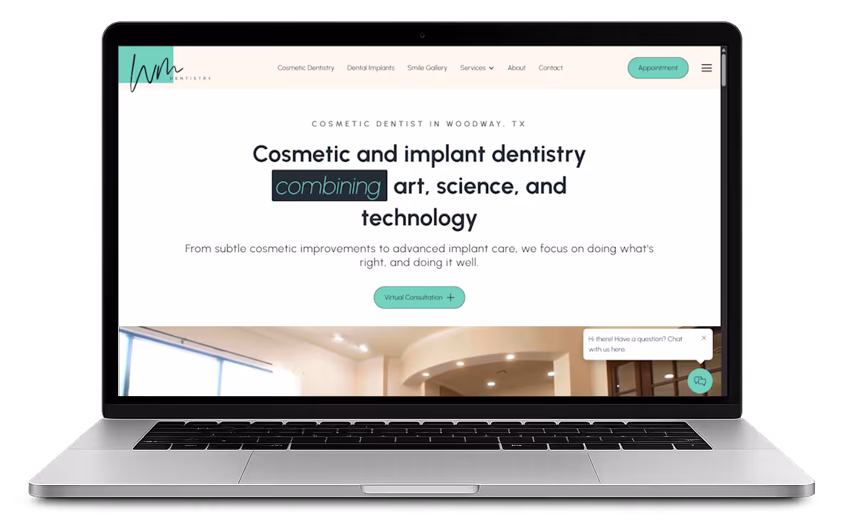 Laptop screen showing a dental clinic website with the headline 'Cosmetic and implant dentistry combining art, science, and technology' and a button for virtual consultation.