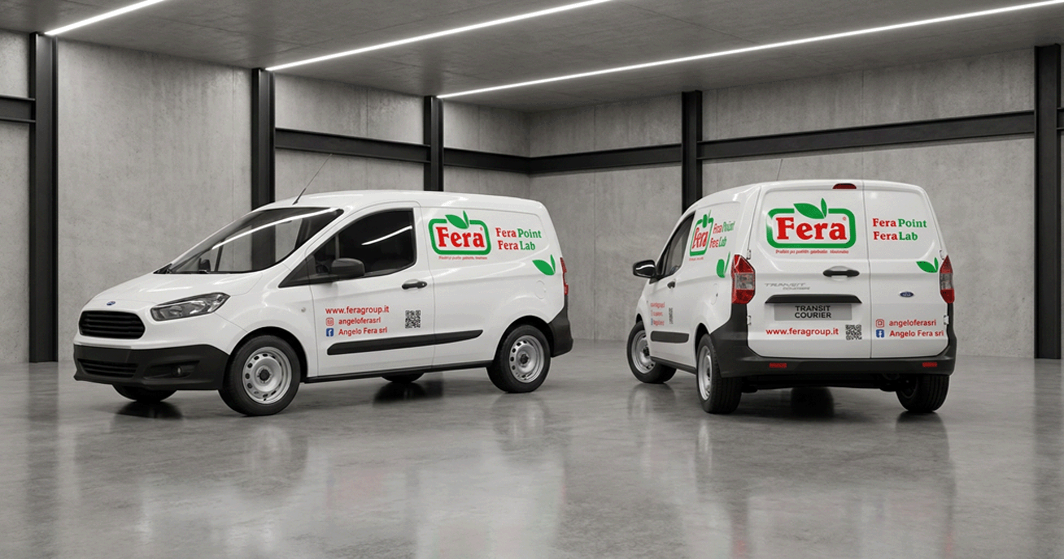 Two white Fera delivery vans parked in a gray industrial garage with concrete walls and floor.