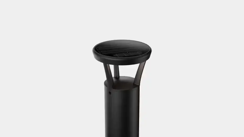 Black solar bollard light with a round, flat top and a translucent diffuser panel.