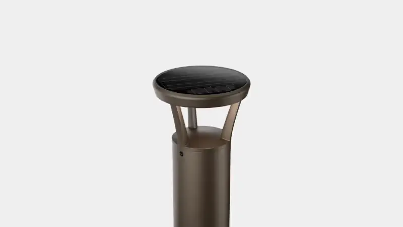 Bronze solar bollard light with a round, flat top and a translucent diffuser panel.