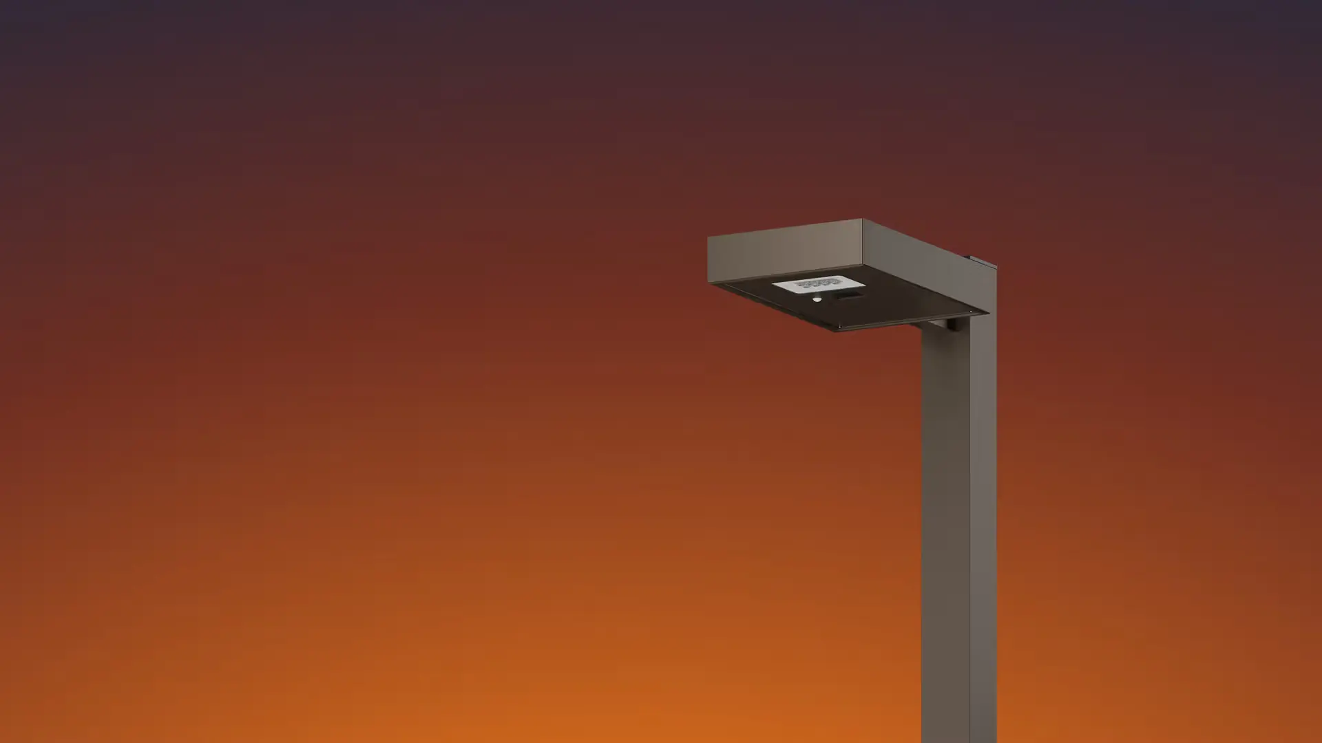 Modern street lamp with a rectangular light fixture against a gradient sunset sky.