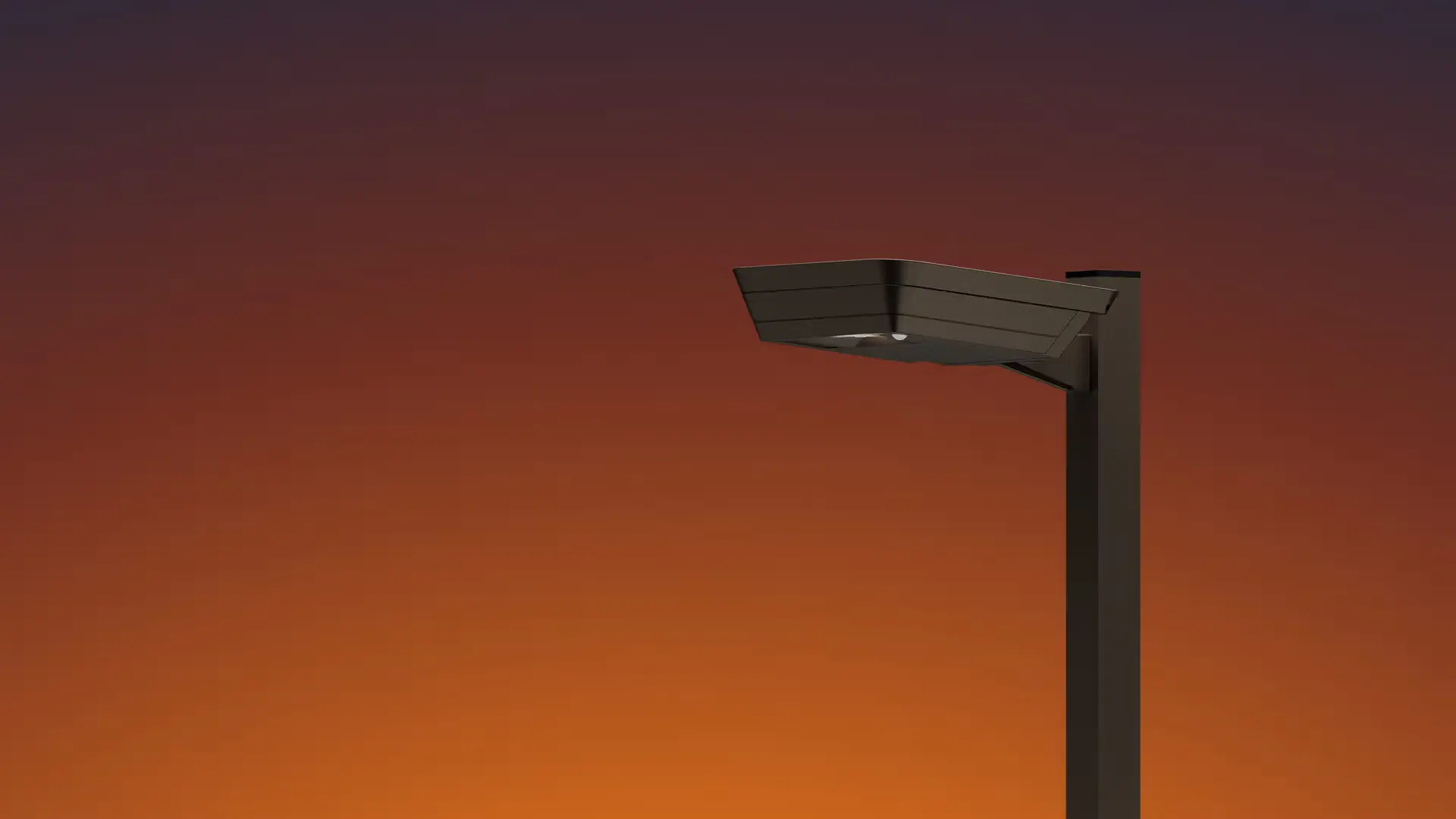 Modern street lamp with a sleek rectangular design against a sunset sky gradient of orange to dark purple.