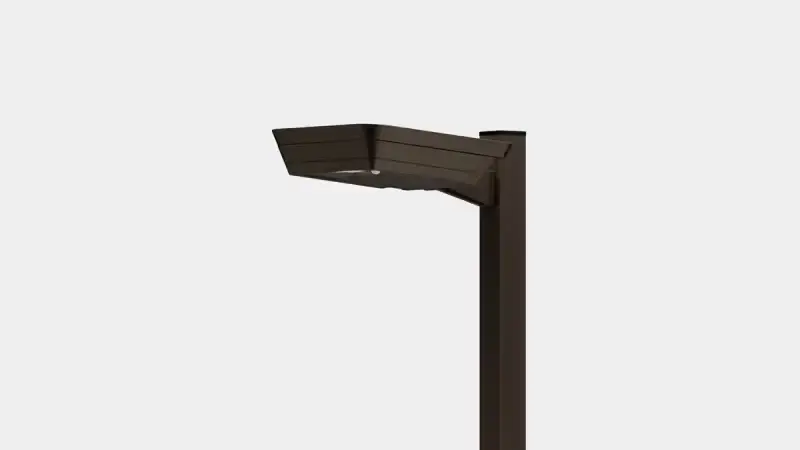 Modern black outdoor street lamp post with a flat, angled light fixture on a gray background.