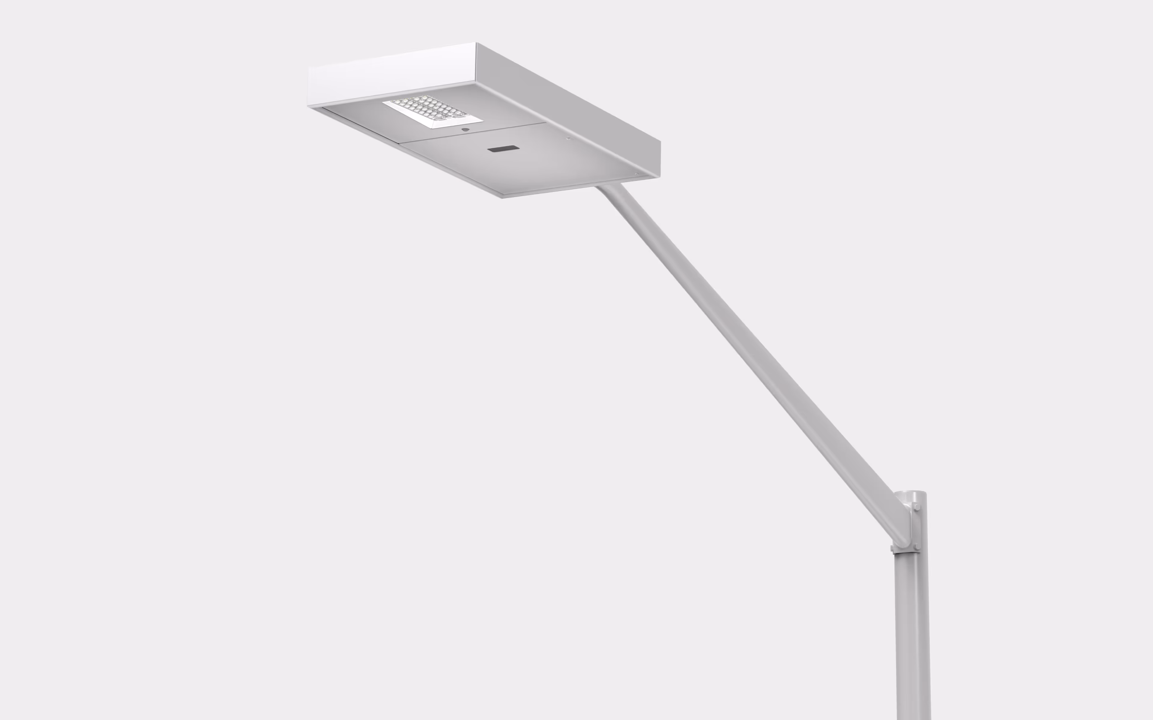 Modern white streetlight with a rectangular LED lamp head mounted on a curved pole.