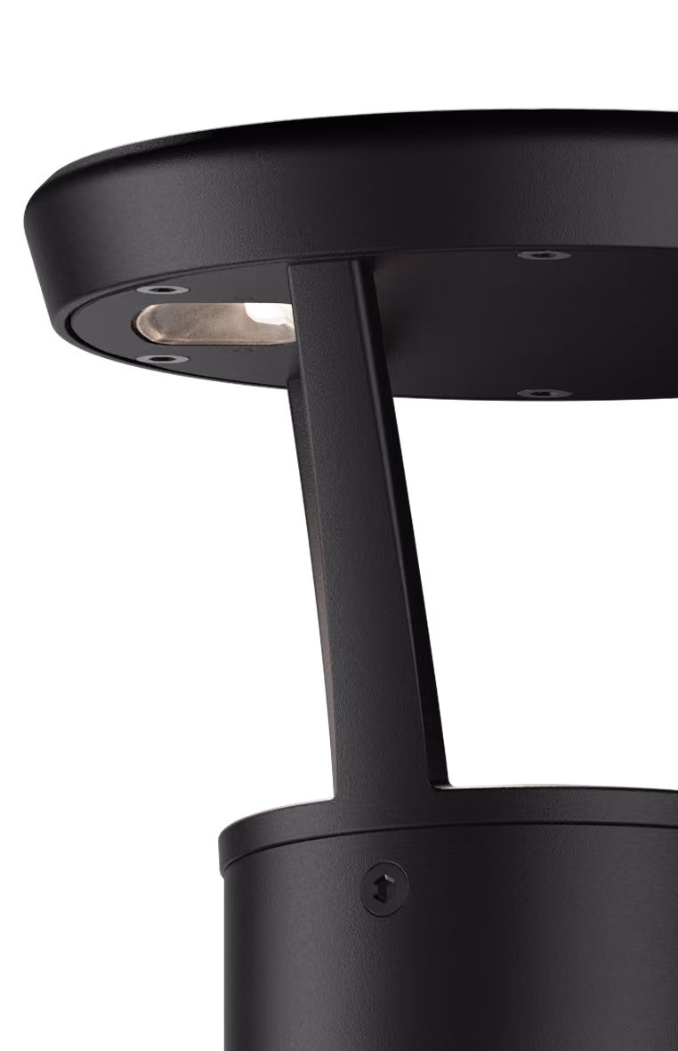 Close-up of a modern black outdoor lamp post with a downward-facing light.