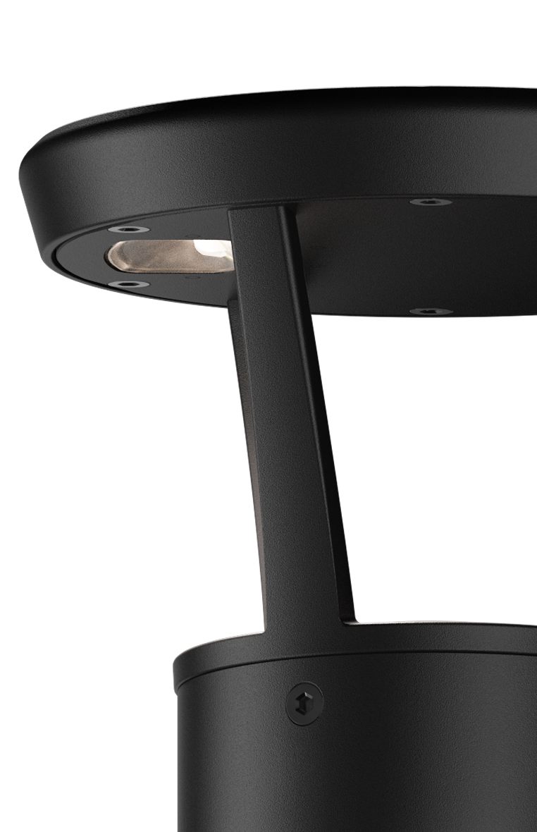 Close-up of a modern black outdoor lamp post with a downward-facing light.