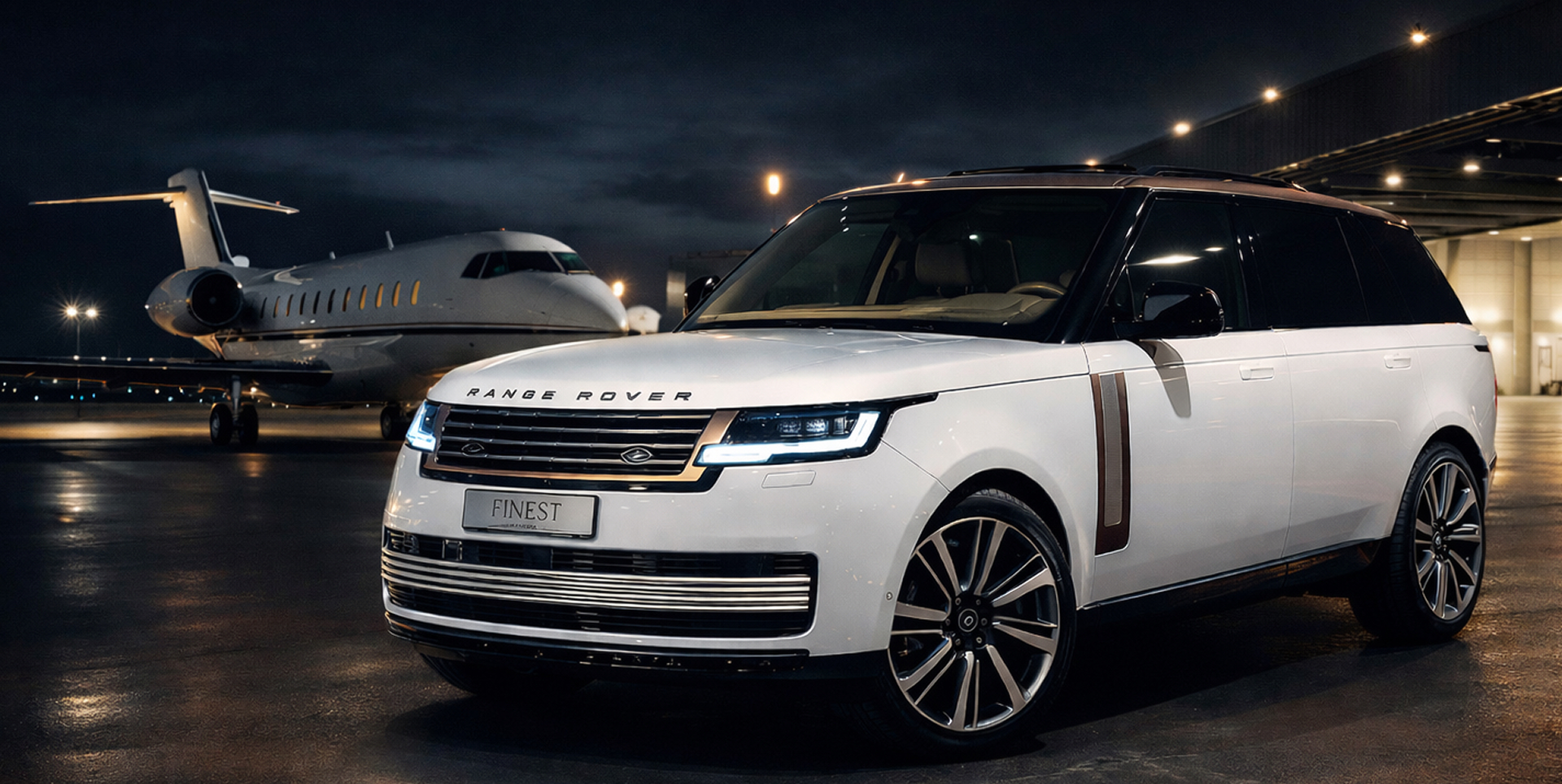 A white Range Rover parked beside a private jet at night