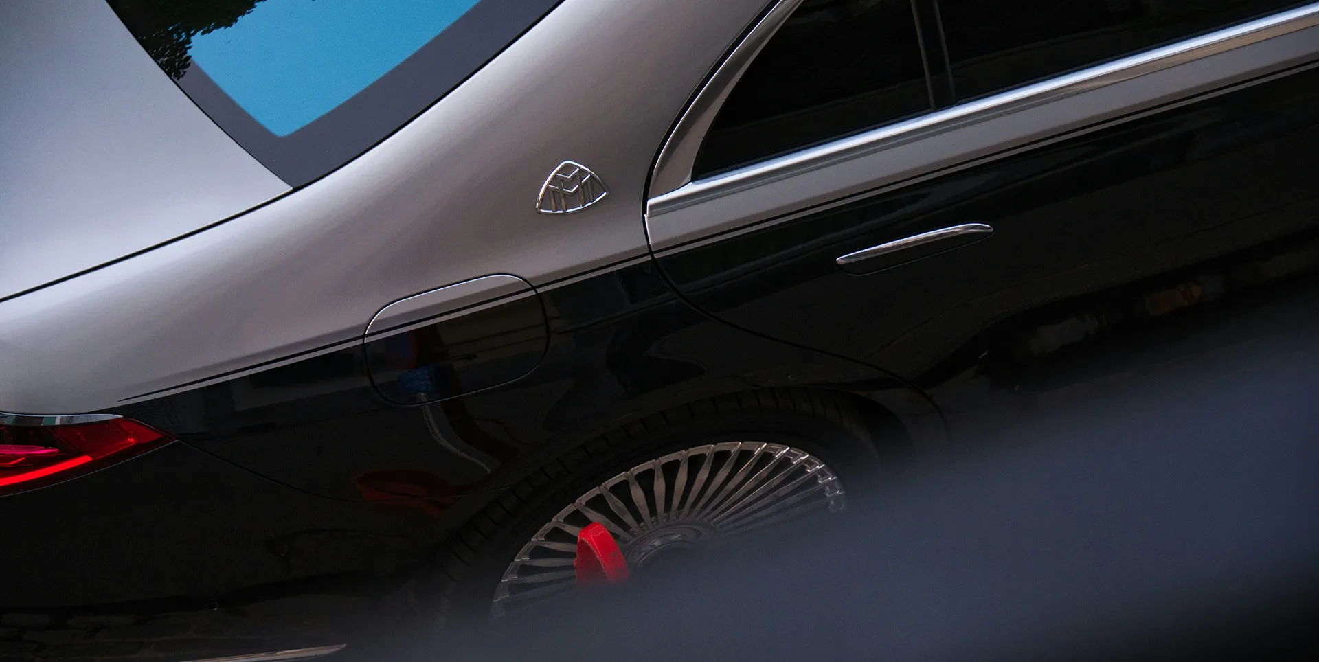 Close-up of the exterior of a two-tone Mercedes-Maybach luxury sedan
