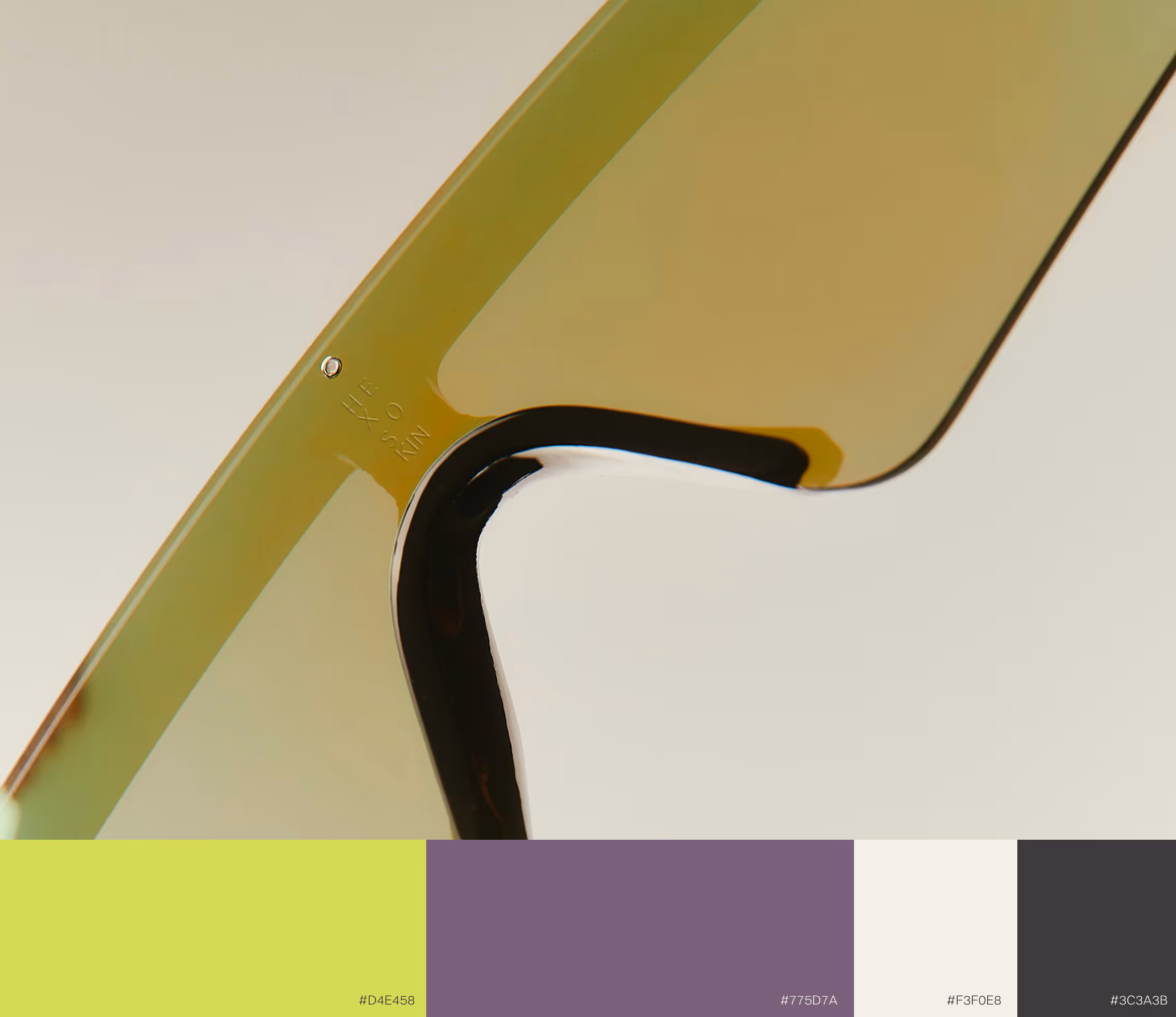 Close-up of green-tinted lens edge with reflections and four color swatches below. Credit Mockup: May-Lee Abel Photo Credit: Daniel Faro