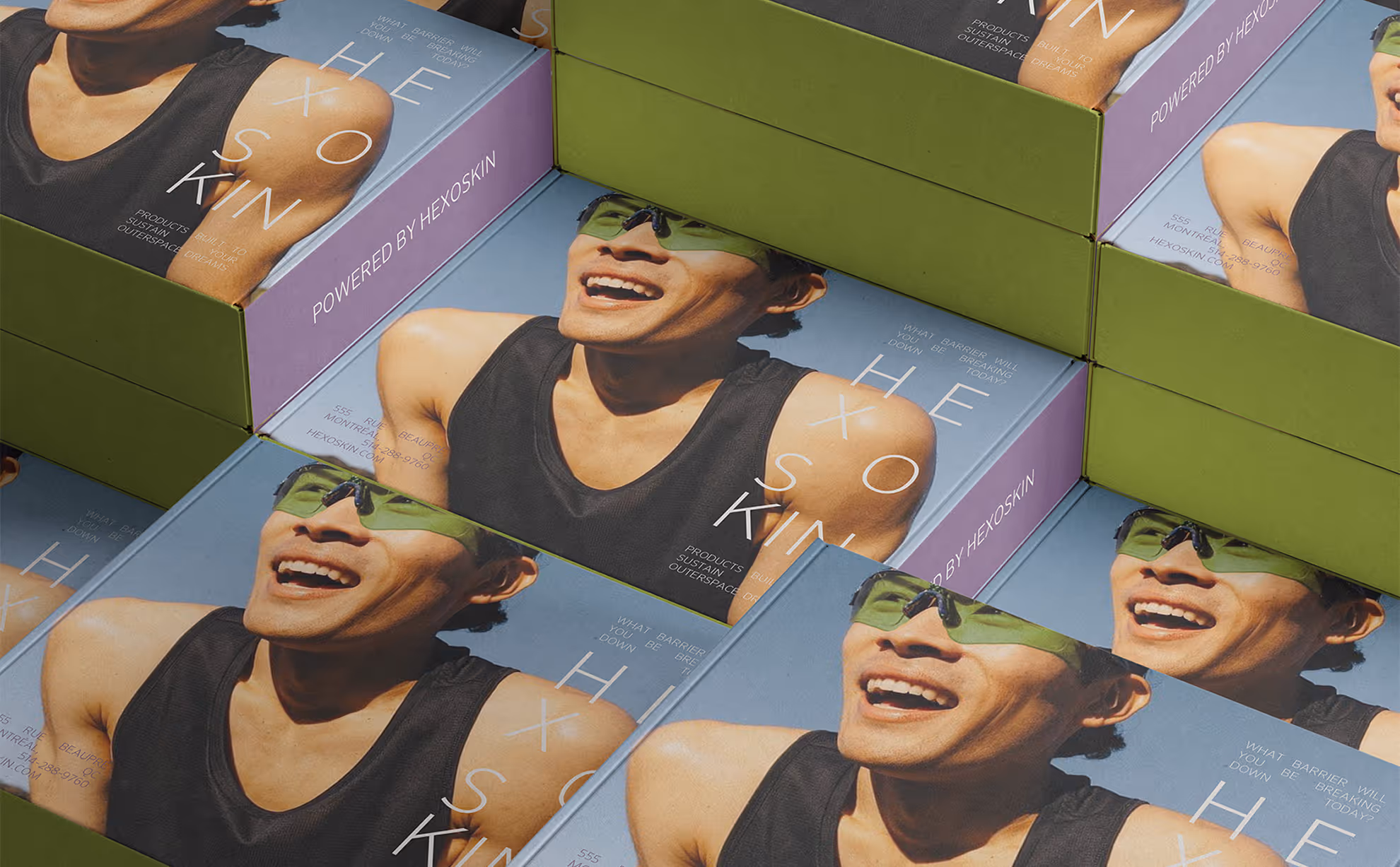 Stacked boxes with smiling man wearing green sunglasses on Hexoskin product packaging. Credit: May-Lee Abel