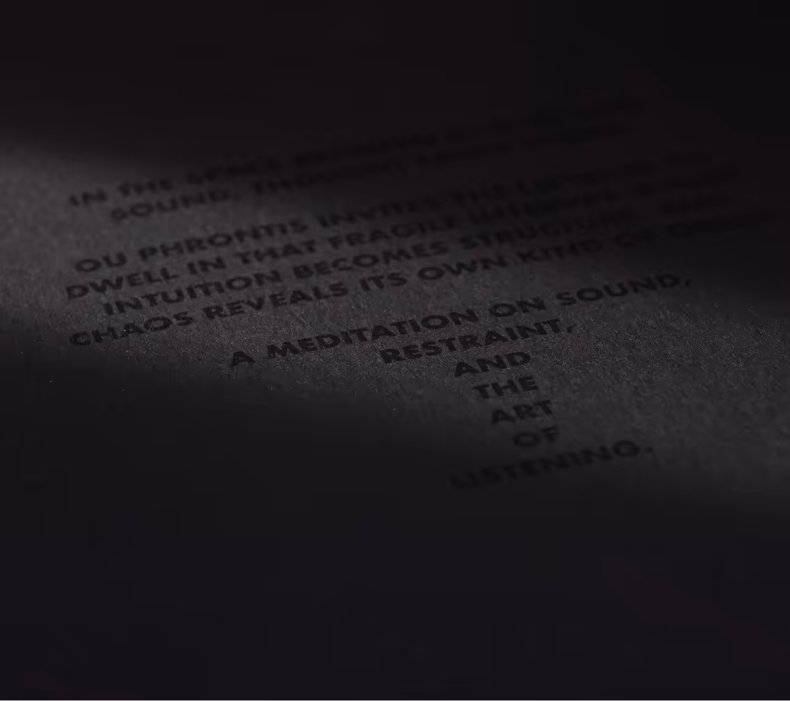 Black paper with partially visible dark text including 'A meditation on sound, restraint, and the art of listening.' Credit: May-Lee Abel