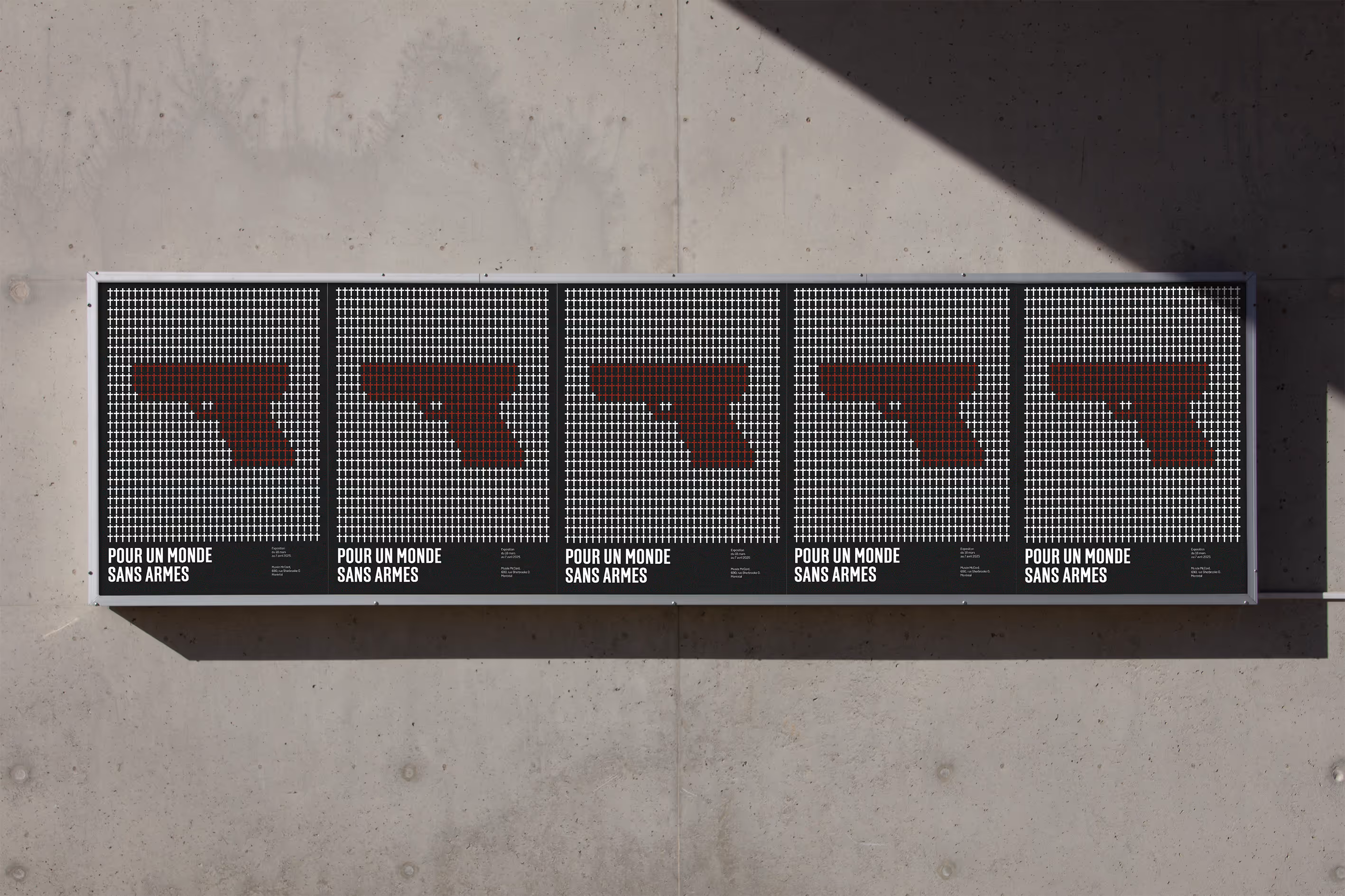 Five posters show a red gun silhouette made of small white crosses with text reading Pour un monde sans armes. Credit: Bendito Mockup
