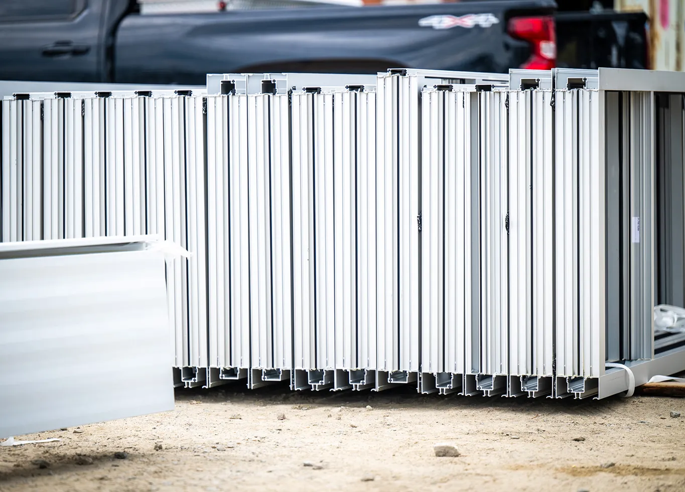 Fabricated aluminum storefront frame sections staged and ready for installation at a commercial job site by BrightLeaf Glass and Metal