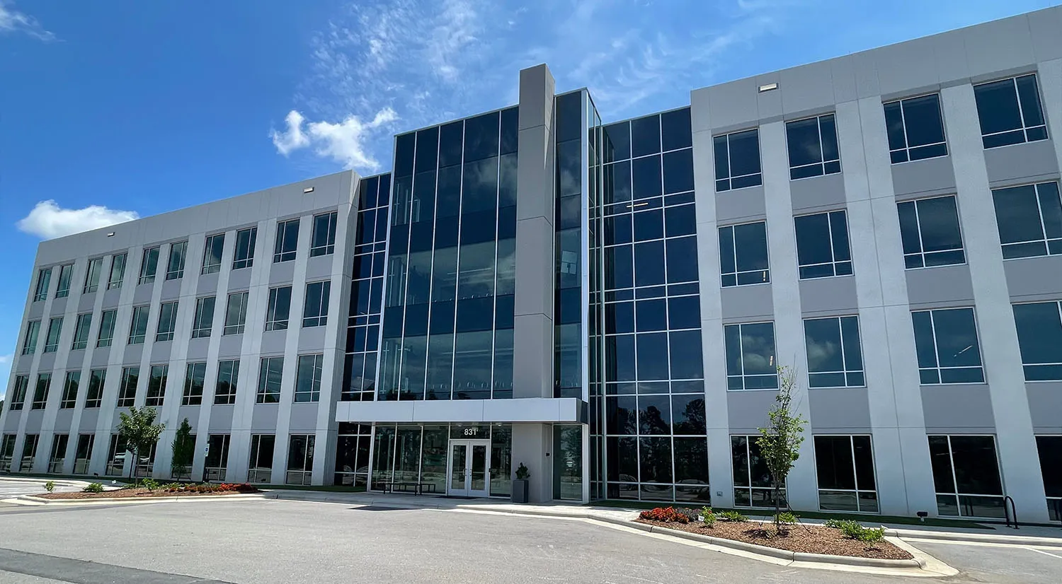 Exterior facade of the Innovation Quarter office building featuring floor-to-ceiling glass curtain wall and aluminum storefront systems installed by BrightLeaf Glass and Metal in North Carolina