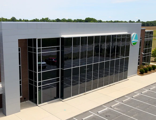 Aerial view of the LREMC facility in Pembroke, NC showcasing a completed glass curtain wall and aluminum storefront system installed by BrightLeaf Glass and Metal