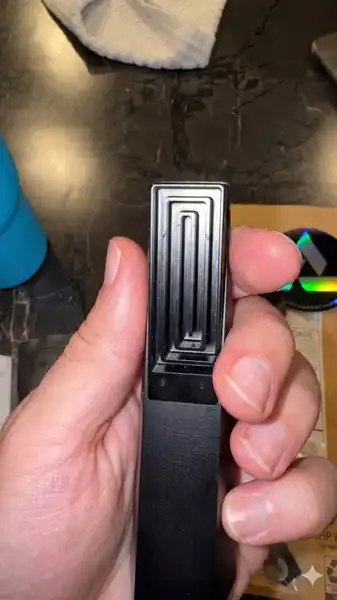 Black Abyss Tempest pipe close-up in hand showing labyrinth interior detail
