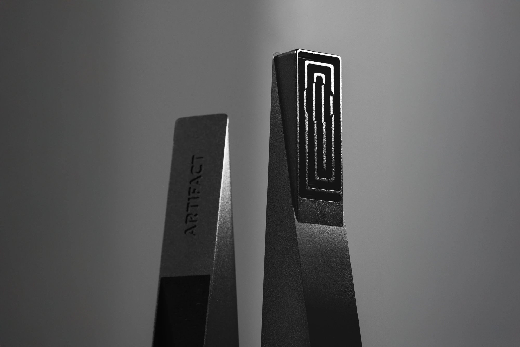 Black Abyss Tempest magnetic cooling pipe standing upright with illuminated square labyrinth interior, photographed against a dark gradient background with dramatic studio lighting