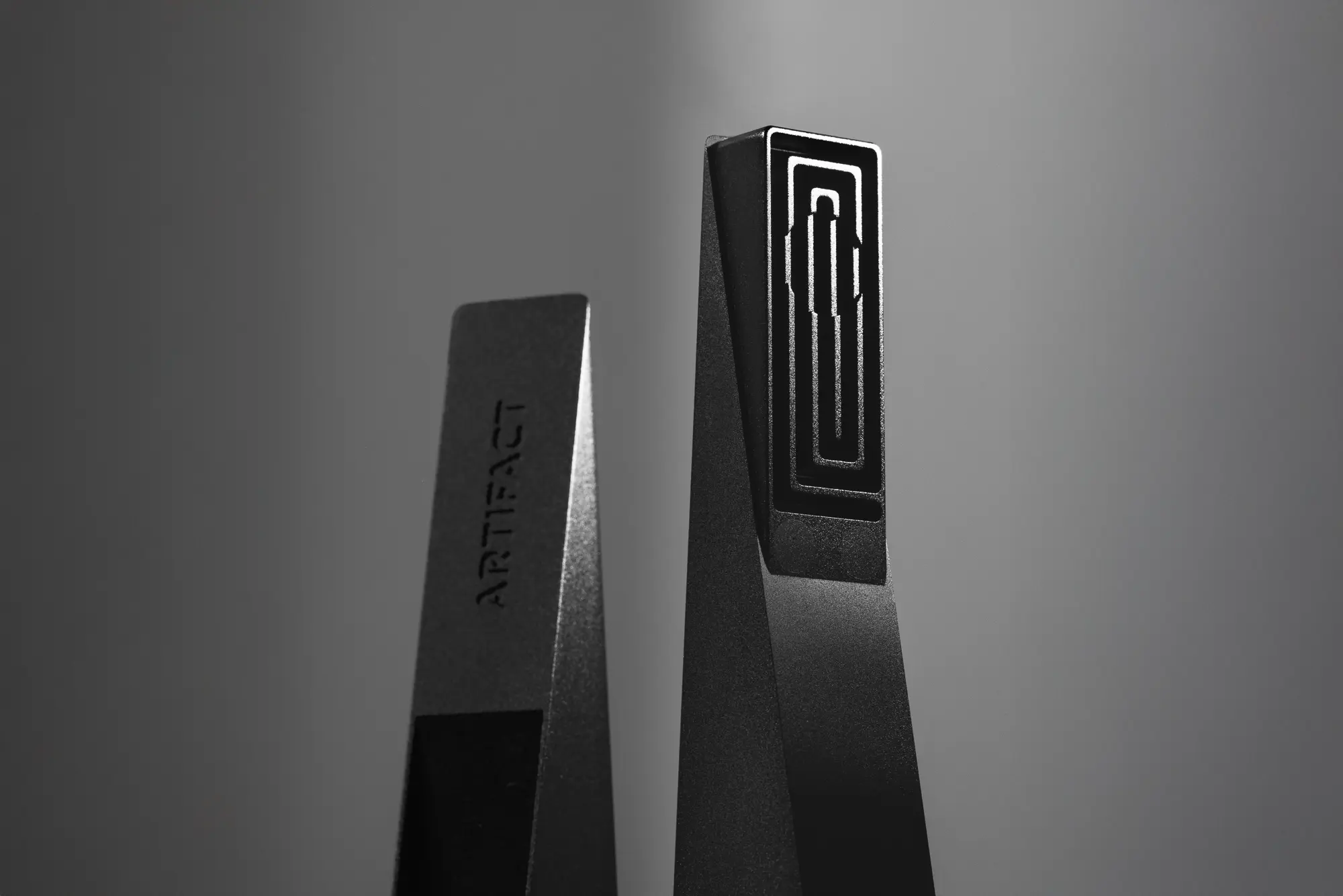 Black Abyss Tempest magnetic cooling pipe standing upright with illuminated square labyrinth interior, photographed against a dark gradient background with dramatic studio lighting