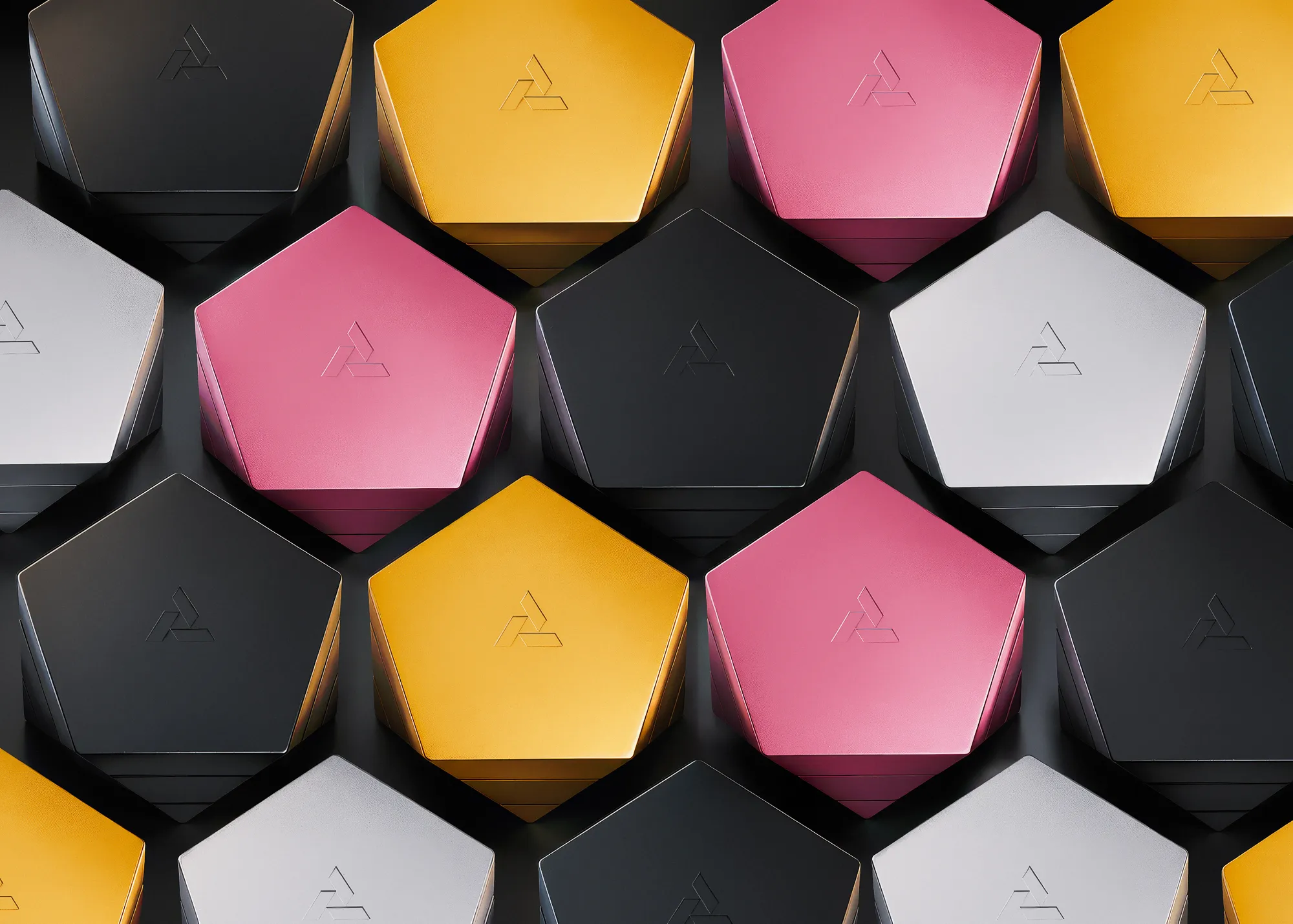 Vesta magnetic vessel collection in black, gold, silver, and pink anodized finishes arranged in repeating geometric pattern on dark background