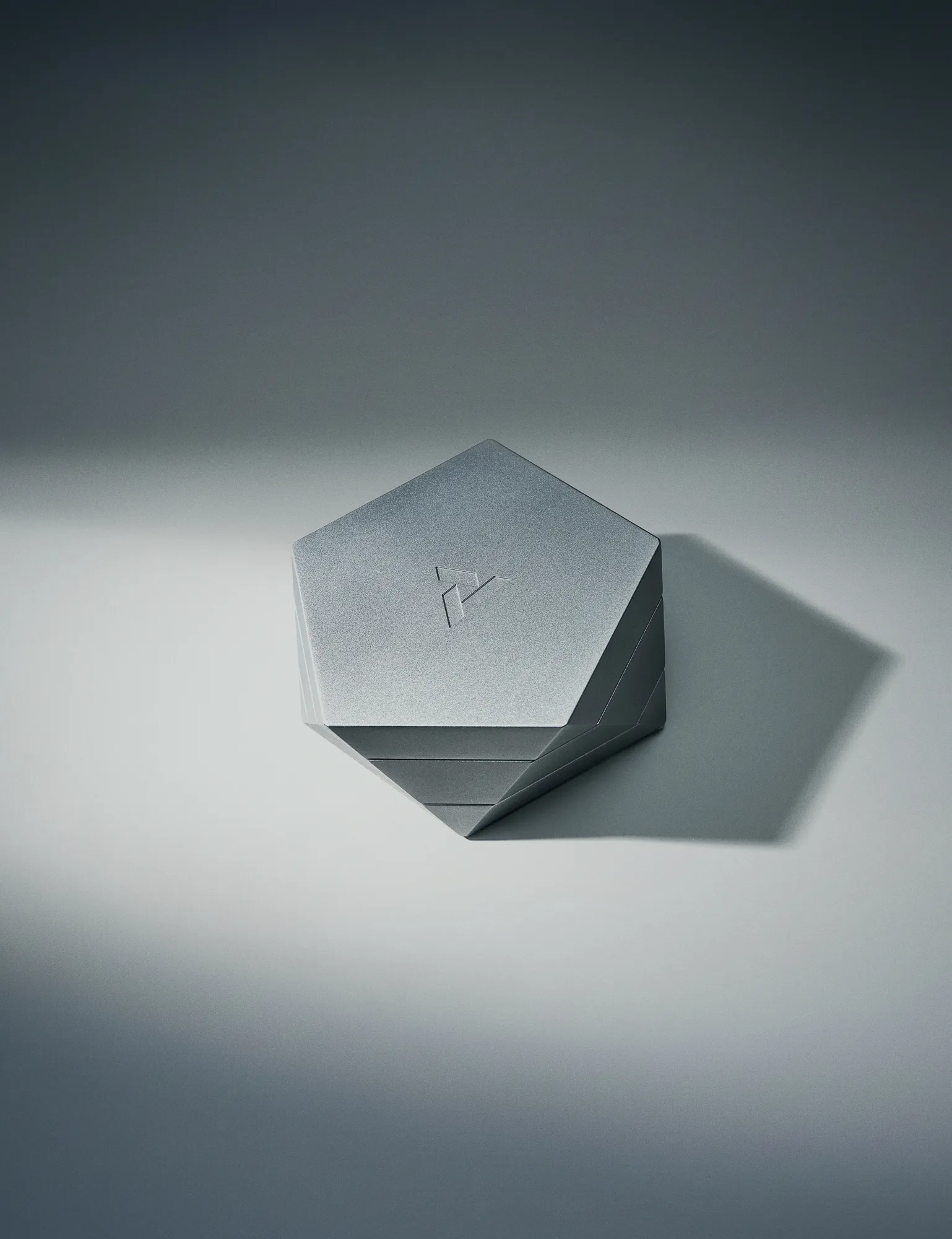 Vesta multi-use container closed with faceted geometric lid and machined aluminum finish