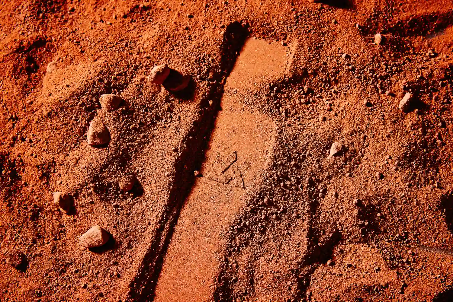 Artifact logo emerging from red desert landscape symbolizing modern relic design