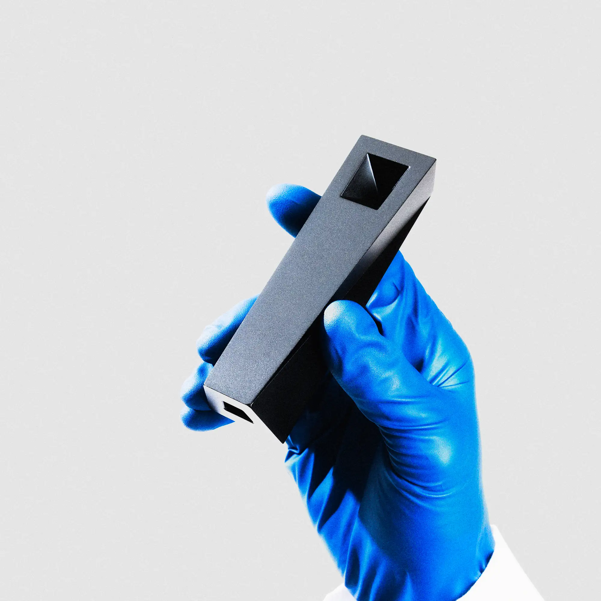 Tempest pipe held in gloved hand showcasing minimalist form and precision-machined aluminum body