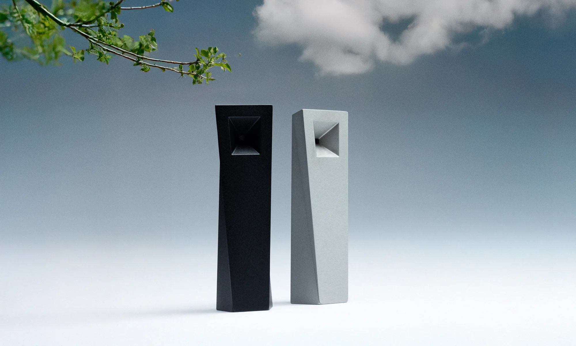Black Tempest Abyss and silver Tempest Mercury magnetic pipes standing side by side in a surreal minimalist landscape
