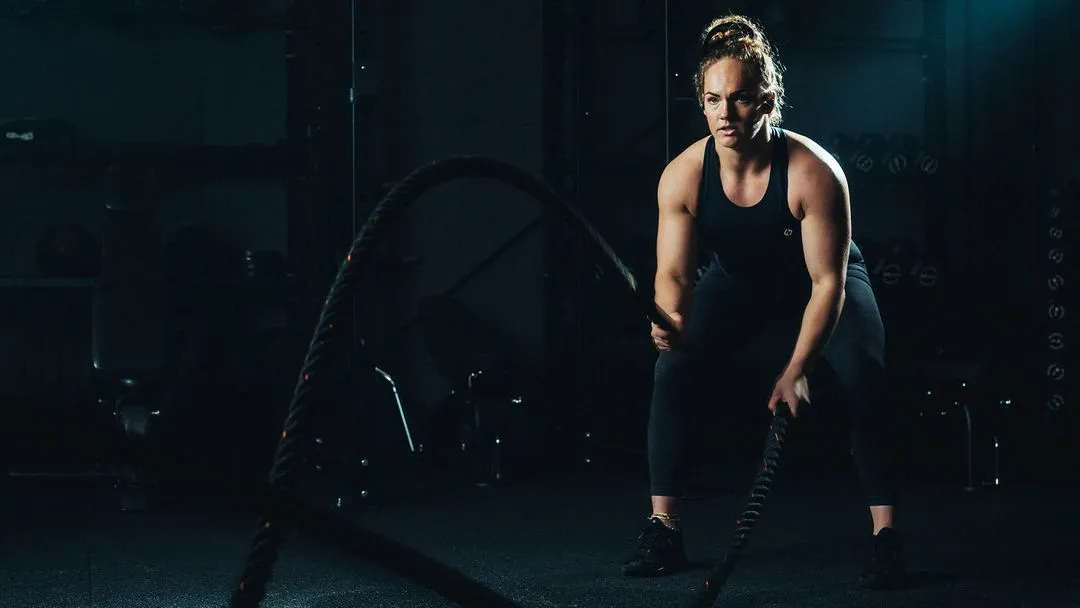 A female athlete using battle ropes