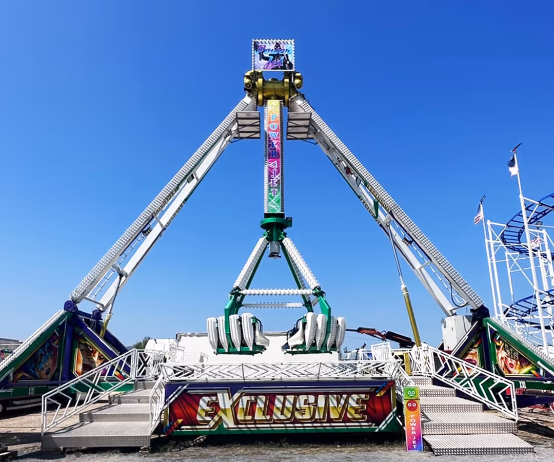 Power Jet carnival ride with swinging seats elevated against a clear blue sky.
