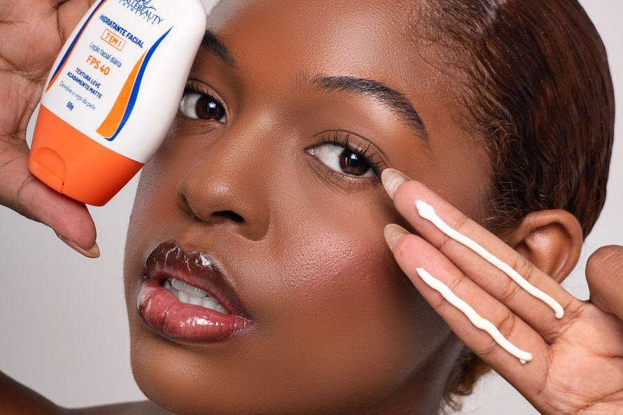 Woman applying facial sunscreen to protect her skin after a facial