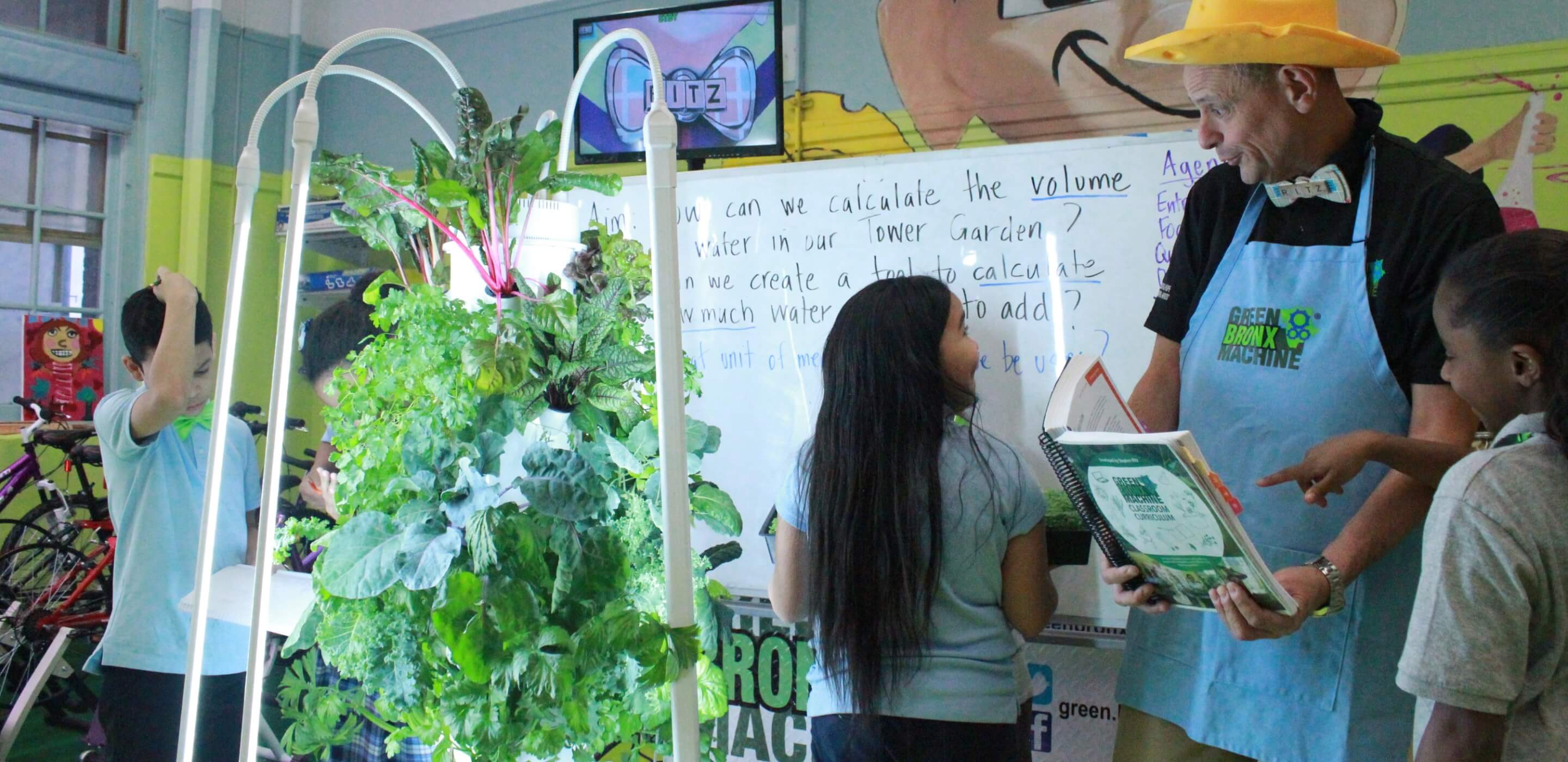 Students learning around a Tower Garden in a Green Bronx Machine classroom